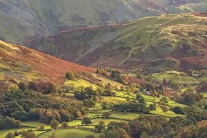Rural farmland below Cumbrian mountains, Martindale, Lake District, Cumbria, England