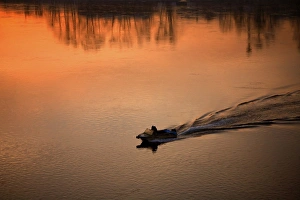 Russia, Siberia, Irkutsk; A boat moving on the main River of the region Russia, Siberia, Irkutsk; A boat moving on the main River of the region