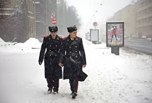 Russia, St. Petersburg; Two student soldiers walking in a snow storm