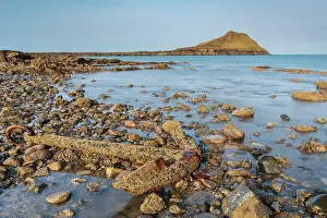 West Glamorgan Prints: Rusted shipwreck anchor on the rocky shoreline near Worm's Head on the Gower Peninsula