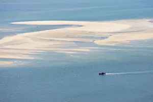 Vastness Prints: Sado river and the Atlantic Ocean with a fishing boat arriving at Setubal, Portugal