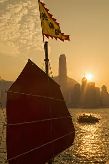 Images Dated 17th February 2015: Sail of Aqua Luna junk boat and Central skyline at sunset, Hong Kong Island, Hong Kong