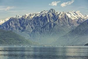 Sail boats on the waters of the northern branch of Lake Como with the Sasso Manduino