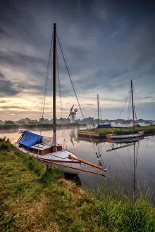 Vertical Gallery: Sailboat framing Thurne Mill, Norfolk Broads, Norfolk, England