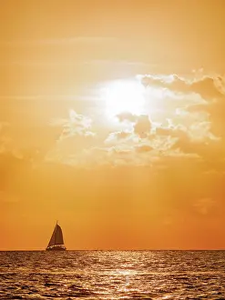 Flare Prints: Sailboat by the west coast of Cozumel Island at sunset, Quintana Roo State, Mexico