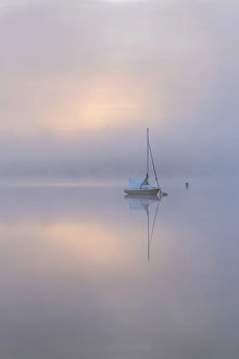 Images Dated 19th May 2017: Sailing boat in misty conditions at dawn on a reflective Wimbleball Lake, Exmoor National Park