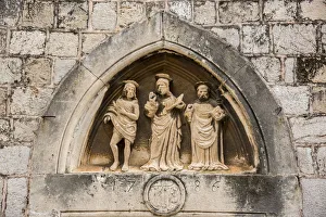 The three saints statues carved above the entrance door of Church of St Luke, Dubrovnik The three saints statues carved above the entrance door of Church of St Luke, Dubrovnik