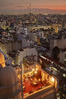 Images Dated 11th March 2022: The 'Salon 1923'Rooftop Bar of the Palacio Barolo and the Buenos Aires skyline at sunset
