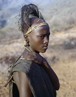 Head Dress Collection: A Samburu boy in reflective mood after his circumcision