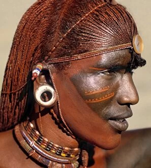 African Culture Collection: A Samburu warrior resplendent with long, braided, Ochred hair