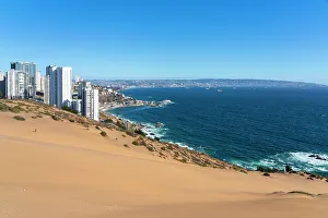 Images Dated 13th September 2022: Sand dunes with high-rise buildings on coast and distant view of Vina del Mar and Valparaiso, Concon