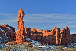Eroded Prints: Sandstone pinnacles with fresh snow in the desert, Arches National Park, Utah, USA