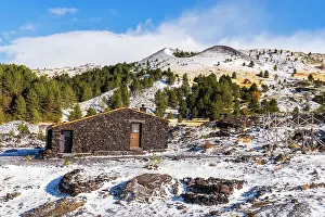 Black Prints: Santa Barbara mountain hut made of volcanic rocks surrounded by craters and lava field
