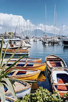 Santa Lucia, Naples, Campania, Italy. Fishing boat and Vesuvius Volcano on background