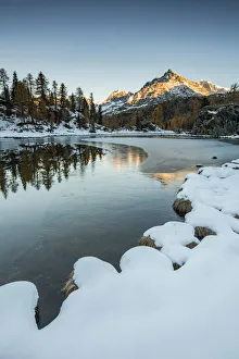 Lombardy Gallery: Sasso Moro peak at dawn reflects itself on the iced waters of Mufule Lake. Valmalenco