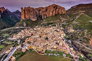 Images Dated 2nd May 2023: Scenic aerial view of the village with the Mallos de Aguero rock formations behind, Aguero