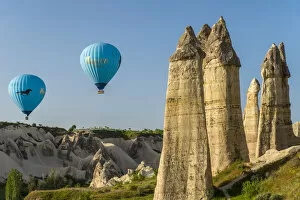 Scenic fairy chimneys landscape with hot air balloons, Goreme, Cappadocia, Turkey