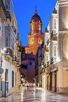 Andalusia Prints: Scenic night view of a street in the old town with cathedral's bell tower in the background