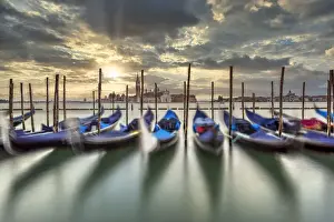 Rowing Boats Prints: Scenic sunrise with moored gondolas and San Giorgio Maggiore island in the backdrop