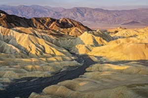 Desolate Gallery: Scenic view of natural rock formations at Zabriskie Point during sunrise