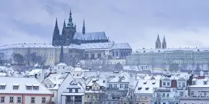 Scenic view of Prague Castle and snow-covered roofs in winter, Prague, Bohemia