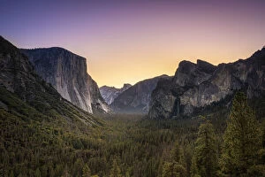 Scenic view of trees by rocky mountains at Tunnel View before sunrise
