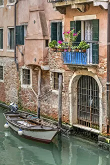 Scenic water canal with moored boat, Venice, Veneto, Italy