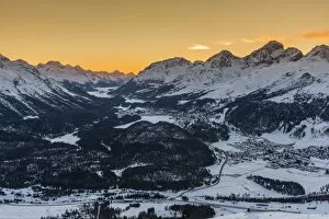 Scenic winter sunset view over Upper Engadine valley from Muottas Muragl with Celerina