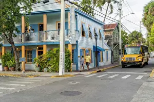 Coach Prints: School bus passing a colourful building, Key West, Florida, USA