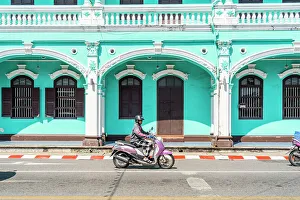 Scooter Prints: Scooter riding past beautiful buildings in the Old town, Phuket, Thailand
