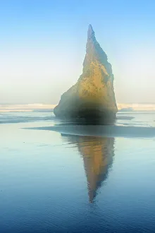Sea stack rocks on Bandon Beach at low tide at dawn, Bandon, Oregon, USA