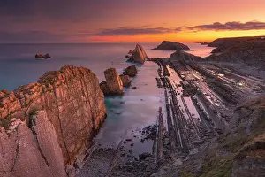 Seascape of Los Urros in the cantabrian sea of Costa Quebrada at sunset. Playa del Portio, Liencres, Cantabria, Spain