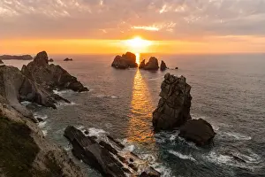 Sunbeams Prints: Seascape of Urro major and Urro Minor at sunset in the cantabrian sea of Playa del Portio