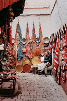 Fabrics Prints: Seller of carpets and fabrics in the souk, Marrakech