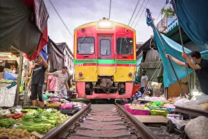 Railway Track Prints: Sellers fast picking up wares just before train passing at Maeklong Railway market