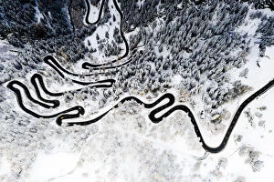 Images Dated 24th November 2020: Serpentine road crossing the snowy woods, aerial view, Maloja Pass, Bregaglia Valley