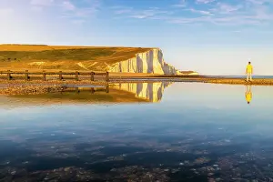 Seven Sisters reflected on Cuckmere Haven beach at sunset, Sussex, England, United Kingdom