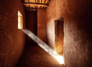 Ouarzazate Prints: Shaft of sunlight shining through the window of a dusty room