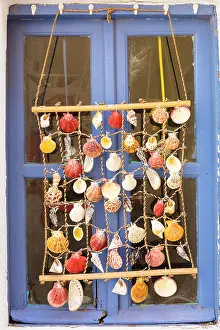 Pyrgos Prints: Shell decoration in front of blue window