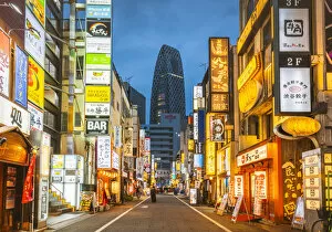Advertisements Gallery: Shinjuku, Tokyo, Kanto region, Japan. Illuminated neon signs at dusk and Cocoon Tower