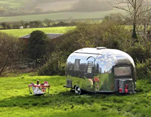 Shiny Airstream caravan parked near Lulworth Cove, Dorset, UK