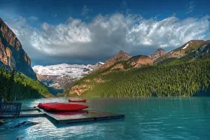 Victoria Prints: Shore of Lake Louise at sunrise with canoes and Canadian Rocky Mountains