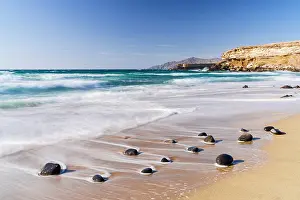 Fuerteventura Prints: Empty shore washed by waves at sunset