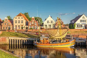 Shrimp boats in the harbor of Greetsiel at sunrise, East Frisia, Lower Saxony, Germany