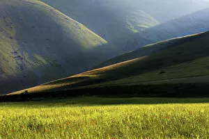 Sibillini national park, Umbria, Italy. Ray of light between mountain ridges, with fields
