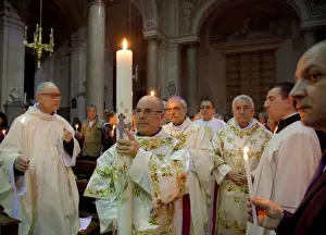 Calendar Prints: Sicily, Italy, Western Europe; The first candle lit is carried to the altar in a procession around the church