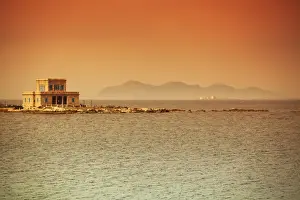 Trapani Region Prints: Sicily, Italy, Western Europe; A villa at sea with the Egadi islands visible in the background in the farthest part of