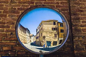 Images Dated 9th July 2015: Siena, Tuscany, Italy. Two people reflected in a street mirror