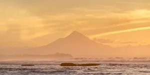 Mount Taranaki Prints: Silhouette of Mount Taranaki at sunset. Tongaporutu, New Plymouth district