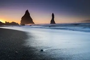 Basalt Rock Prints: Silhouette Reynisdrangar rock formations in sea near Vik i Mydral during sunrise